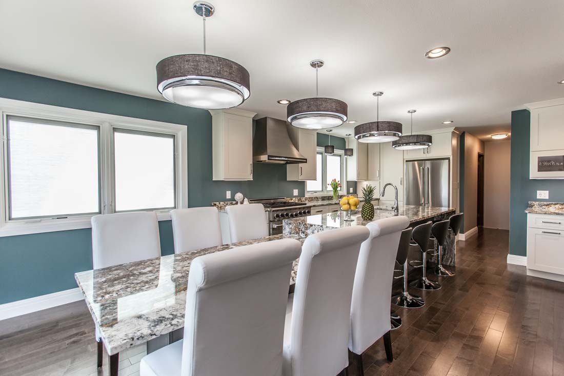 Table with granite surface and six chairs in a contemporary kitchen in Fairfield, IA