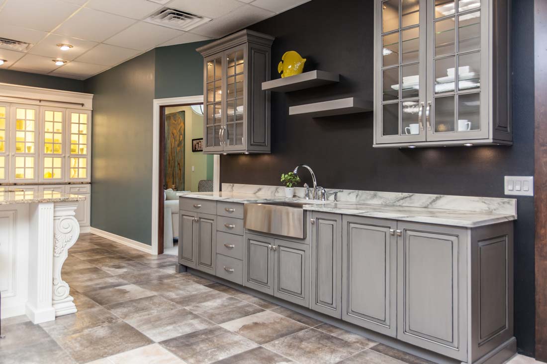 Grey kitchen cabinets with Carrara Marble countertops and floating shelves in Fairfield, Iowa