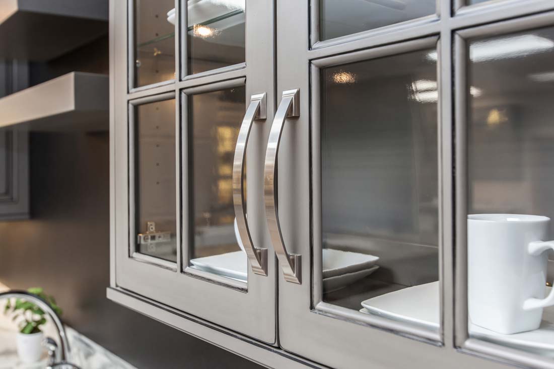 Glass panel grey kitchen cabinet doors in Fairfield, Iowa