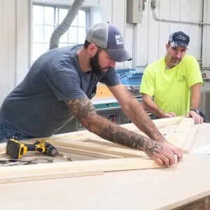 Two carpenters work at JC Huffman Cabinetry.