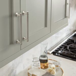 Green cabinets with satin nickel hardware.
