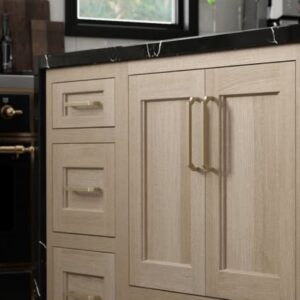 White oak Dura Supreme Cabinets with black counters. As part of 2026 kitchen trends.