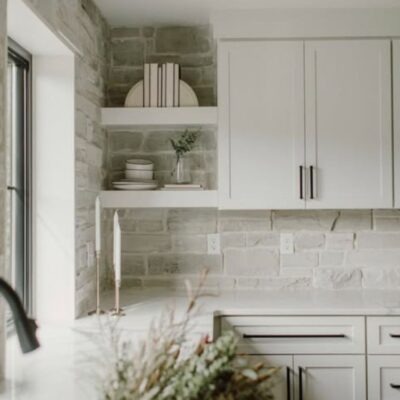 Light gray stone veneer kitchen backsplash.