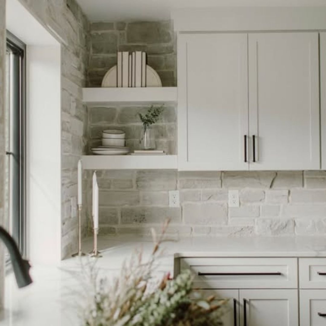 Light gray stone veneer kitchen backsplash.