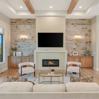 An interior wall with stone veneers next to a fireplace.