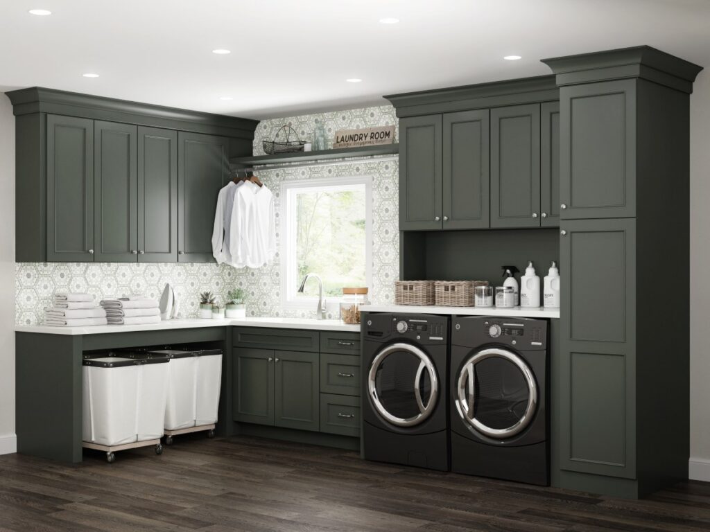 Green custom laundry room cabinetry with built in hampers, hanging storage, upper cabinets, and countertop space for laundry organization.