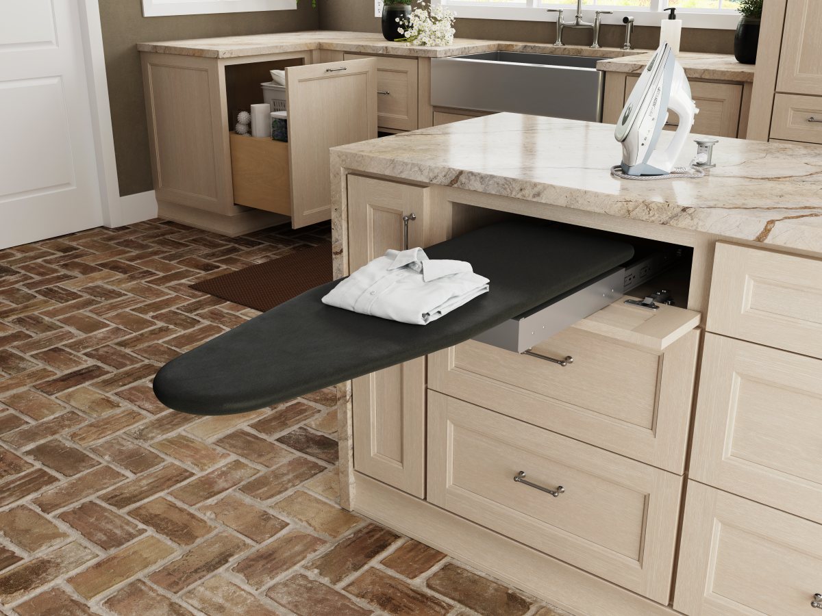 pull-out-ironing-board-laundry-room-remodel Pull out ironing board hidden inside custom laundry room cabinetry for a convenient built in ironing station.