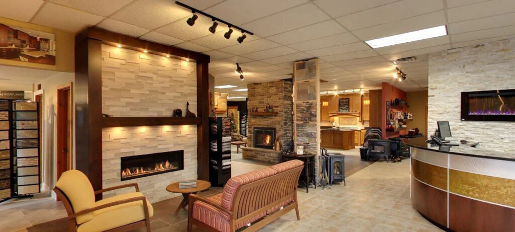 JC Huffman fireplace showroom in Fairfield, Iowa, featuring linear gas fireplace displays and stone surround finishes.